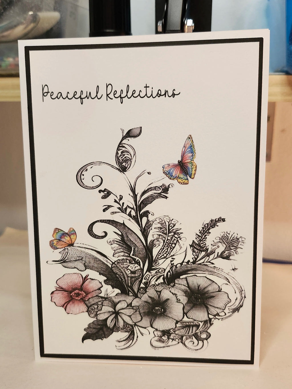 Greeting card with floral design and butterflies on a white background