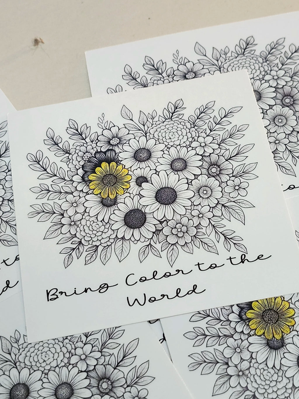 Floral coloring book pages with black outlines and yellow centers on white paper.