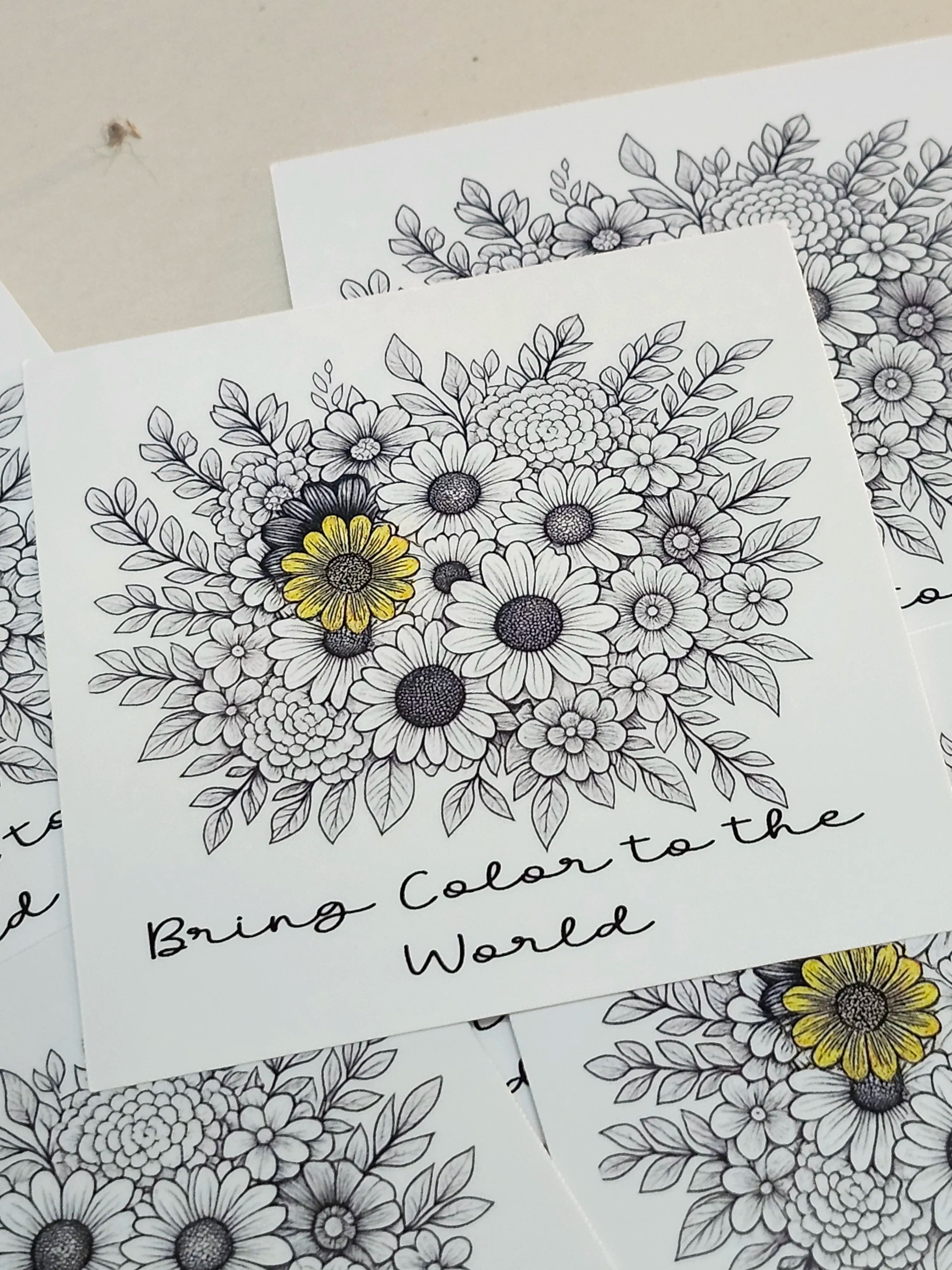 Floral coloring book pages with black outlines and yellow centers on white paper.