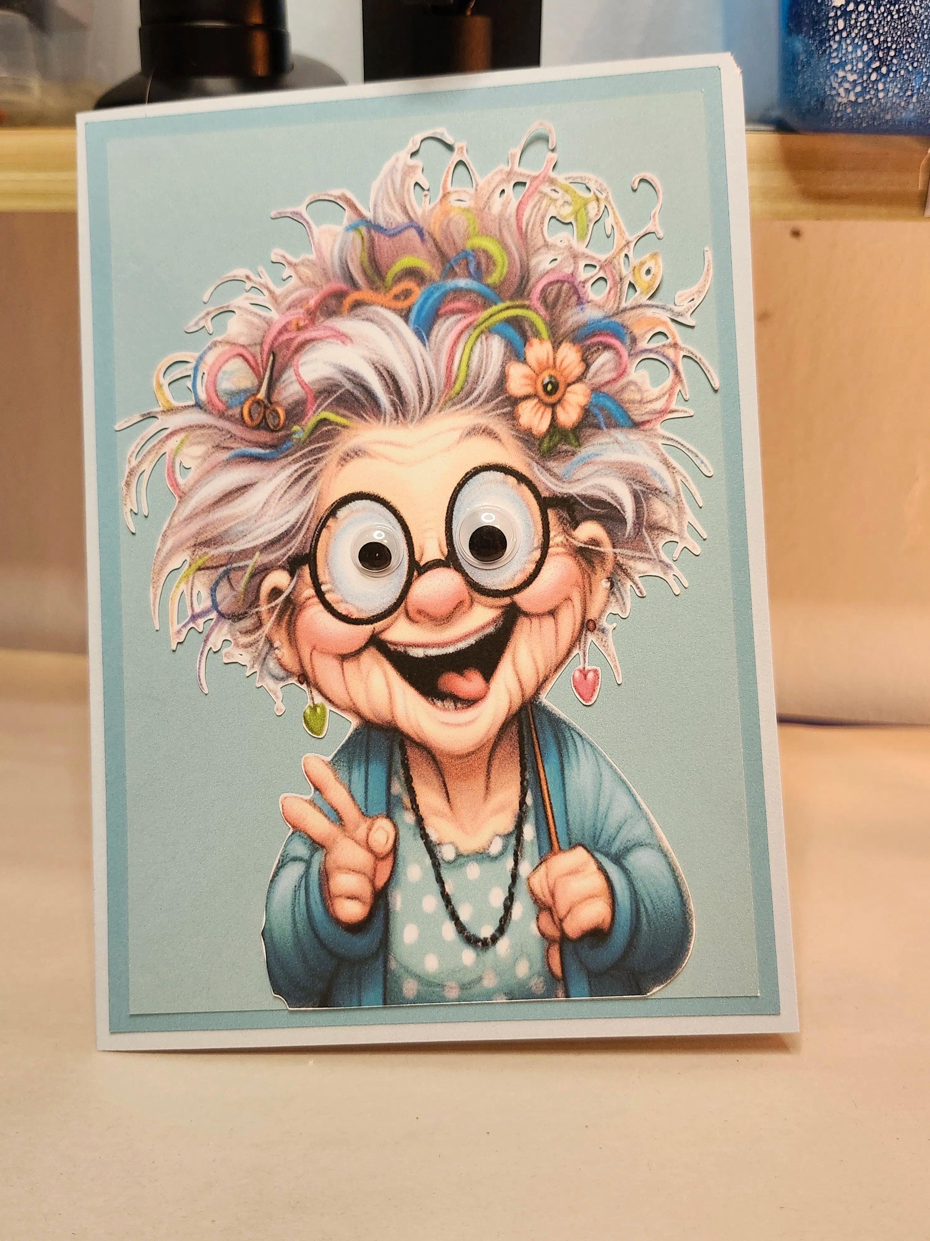 Cartoon character with colorful hair and glasses on a light blue background