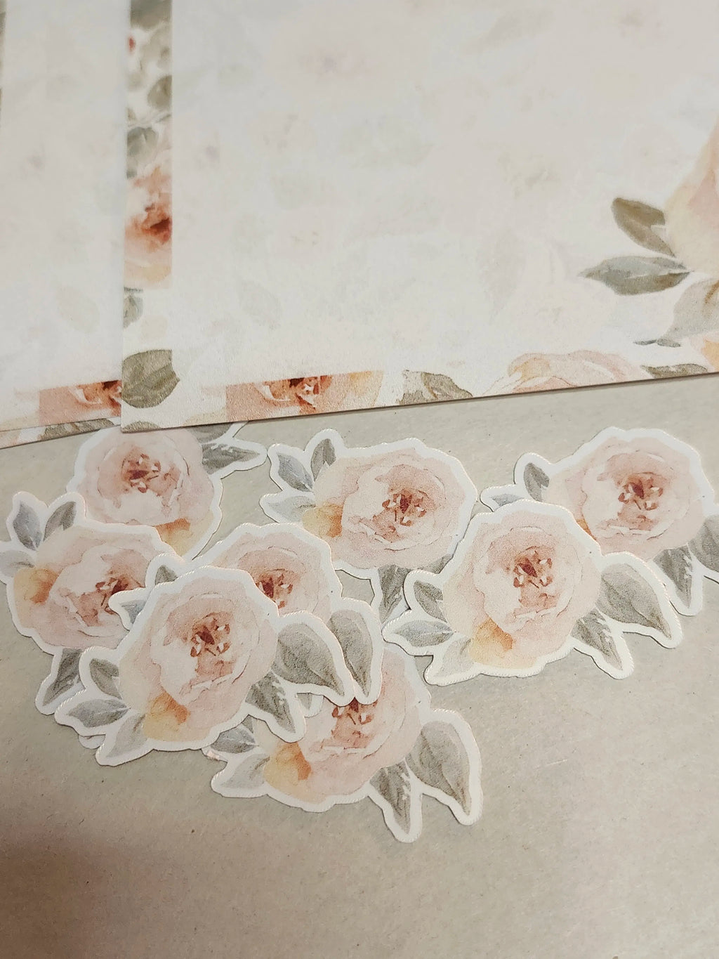 Floral stickers on a textured surface with a mirror reflection.