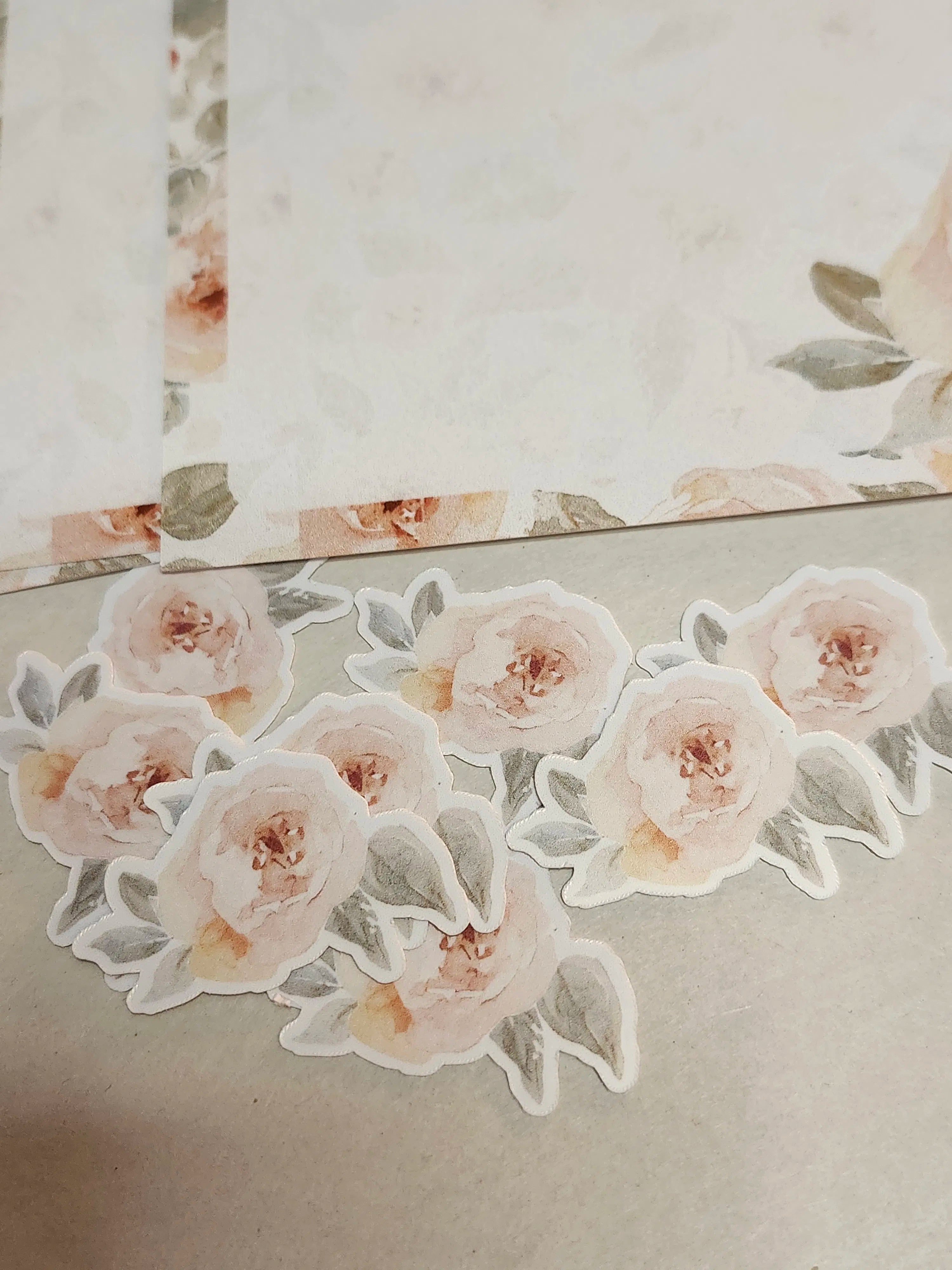 Floral stickers on a textured surface with a mirror reflection.