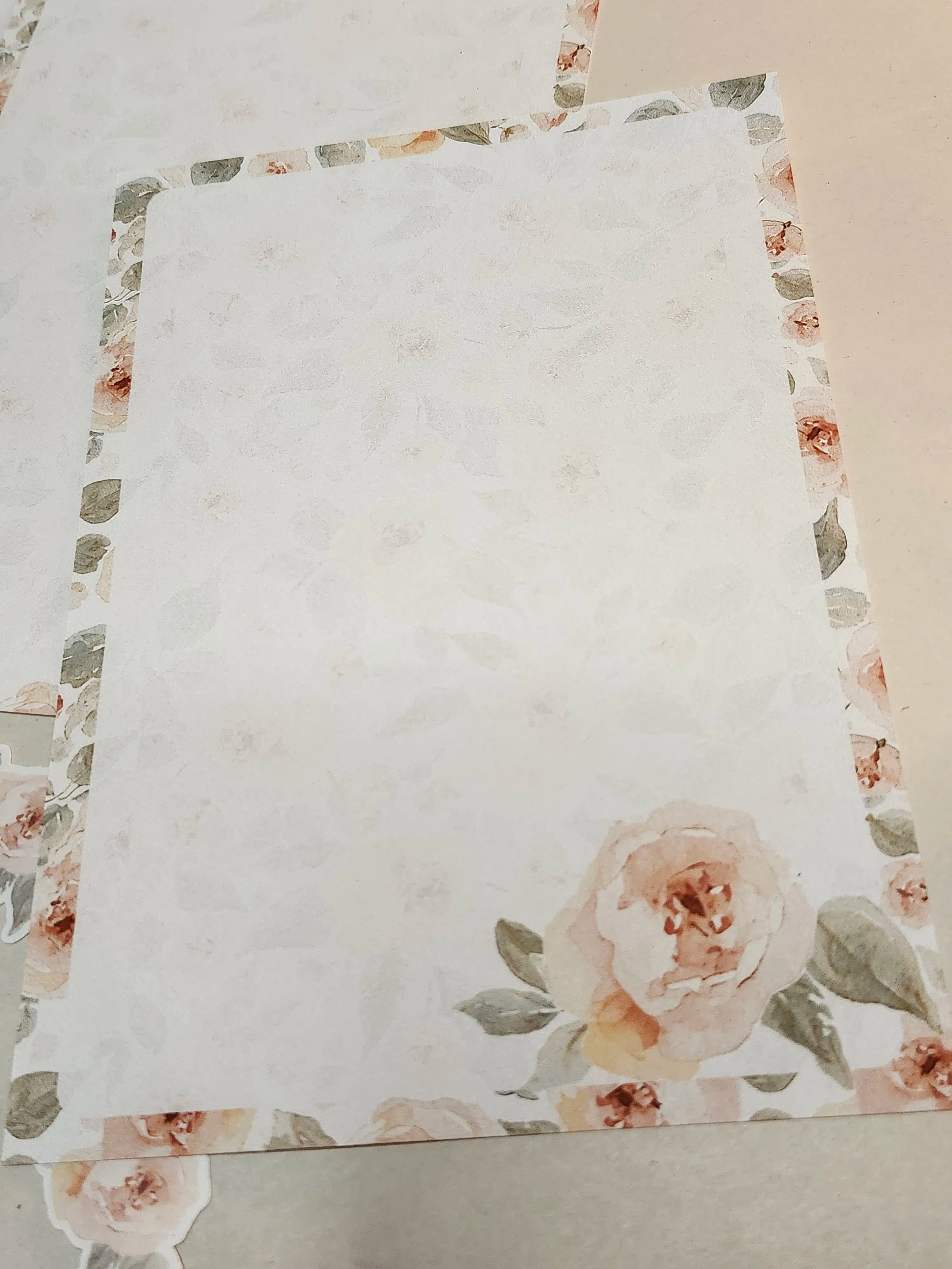 Floral-patterned fabric with a prominent rose design on a plain background