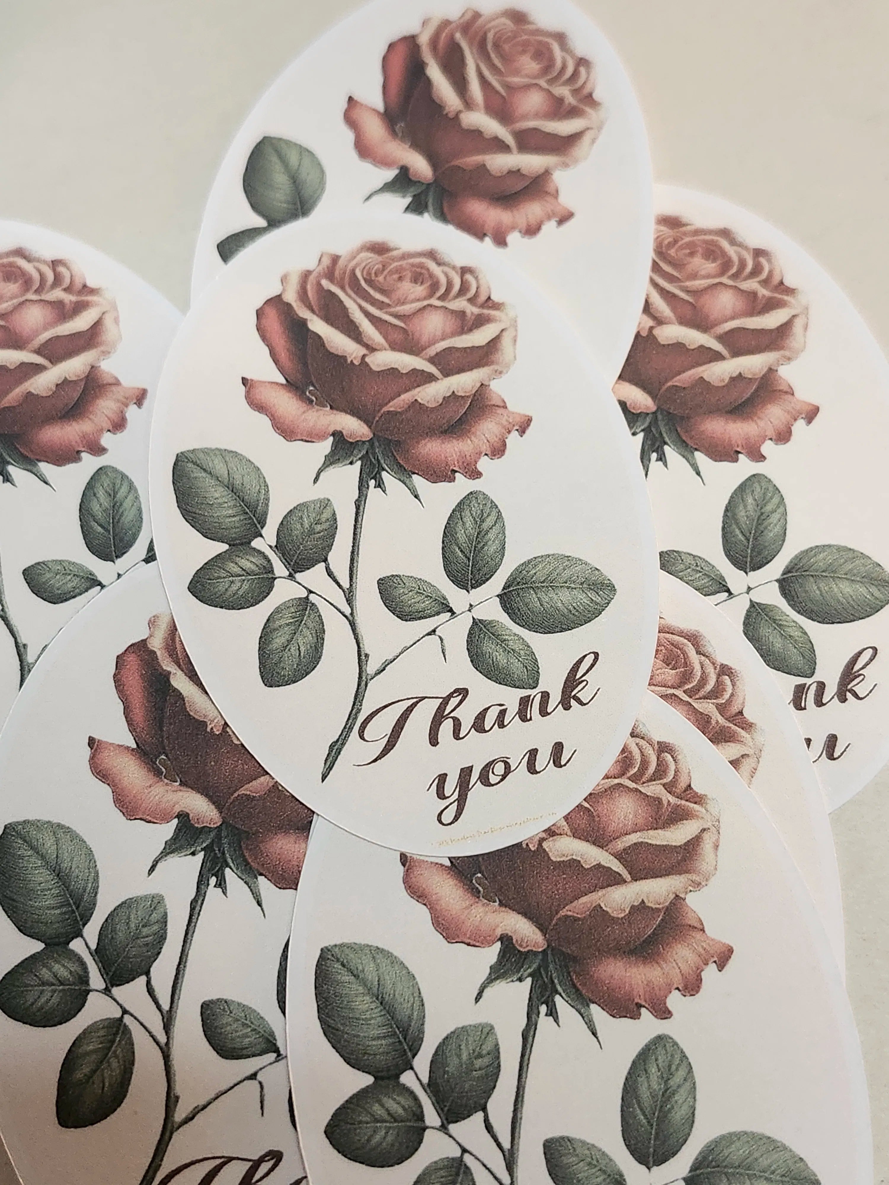 Sticker with roses and 'Thank you' text on a beige background