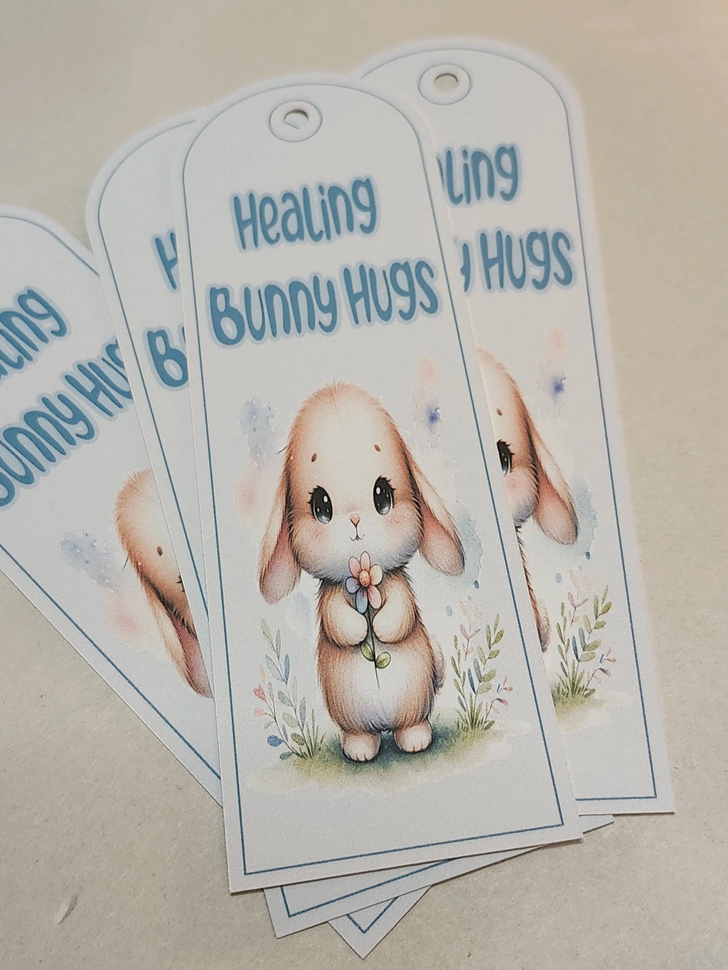 Bookmark with a cartoon bunny and text 'Healing Bunny Hugs' on a beige background