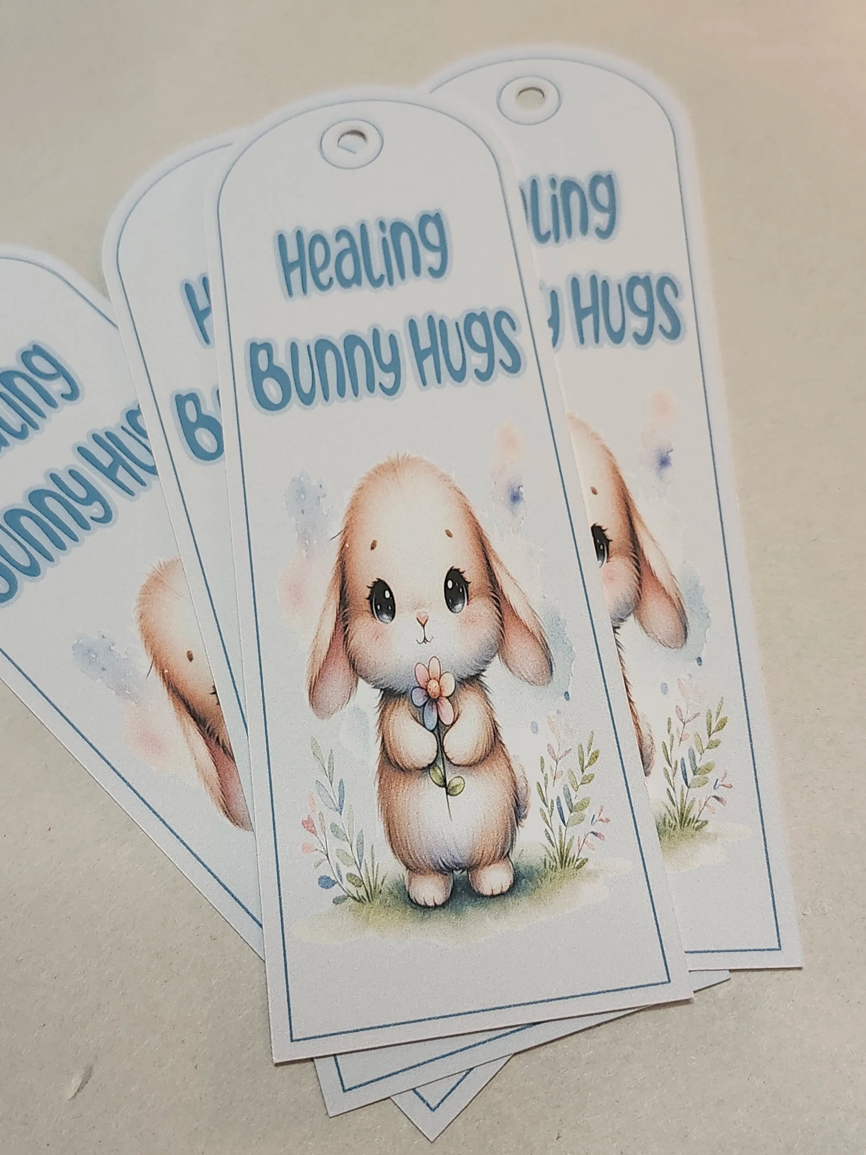 Bookmark with a cartoon bunny and text 'Healing Bunny Hugs' on a beige background