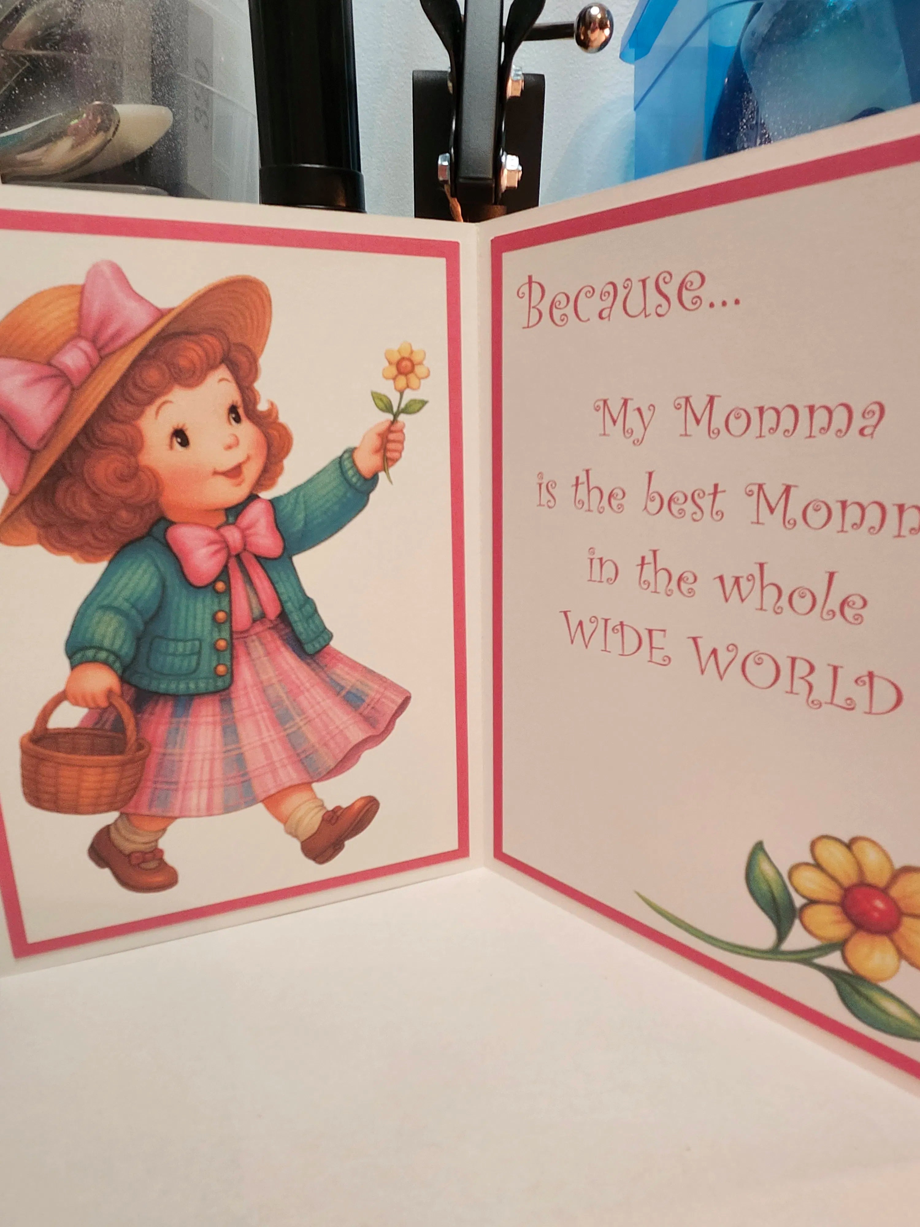 Vintage-style greeting card with a illustration of a girl holding a flower and text about mommies.