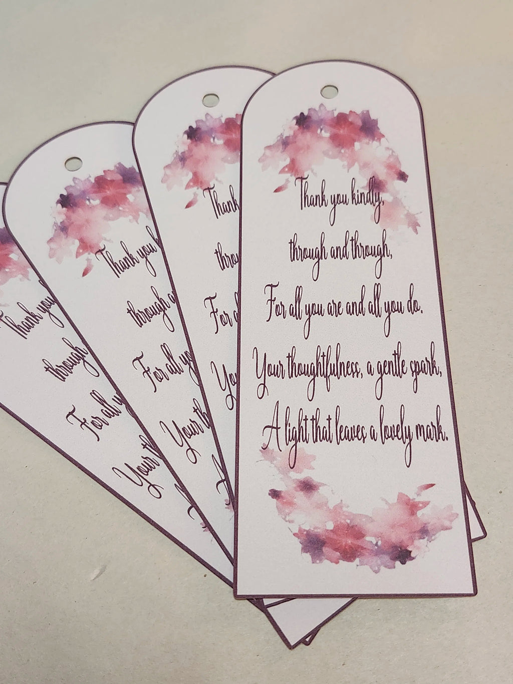 Bookmarks with floral designs and heartfelt messages on a beige background