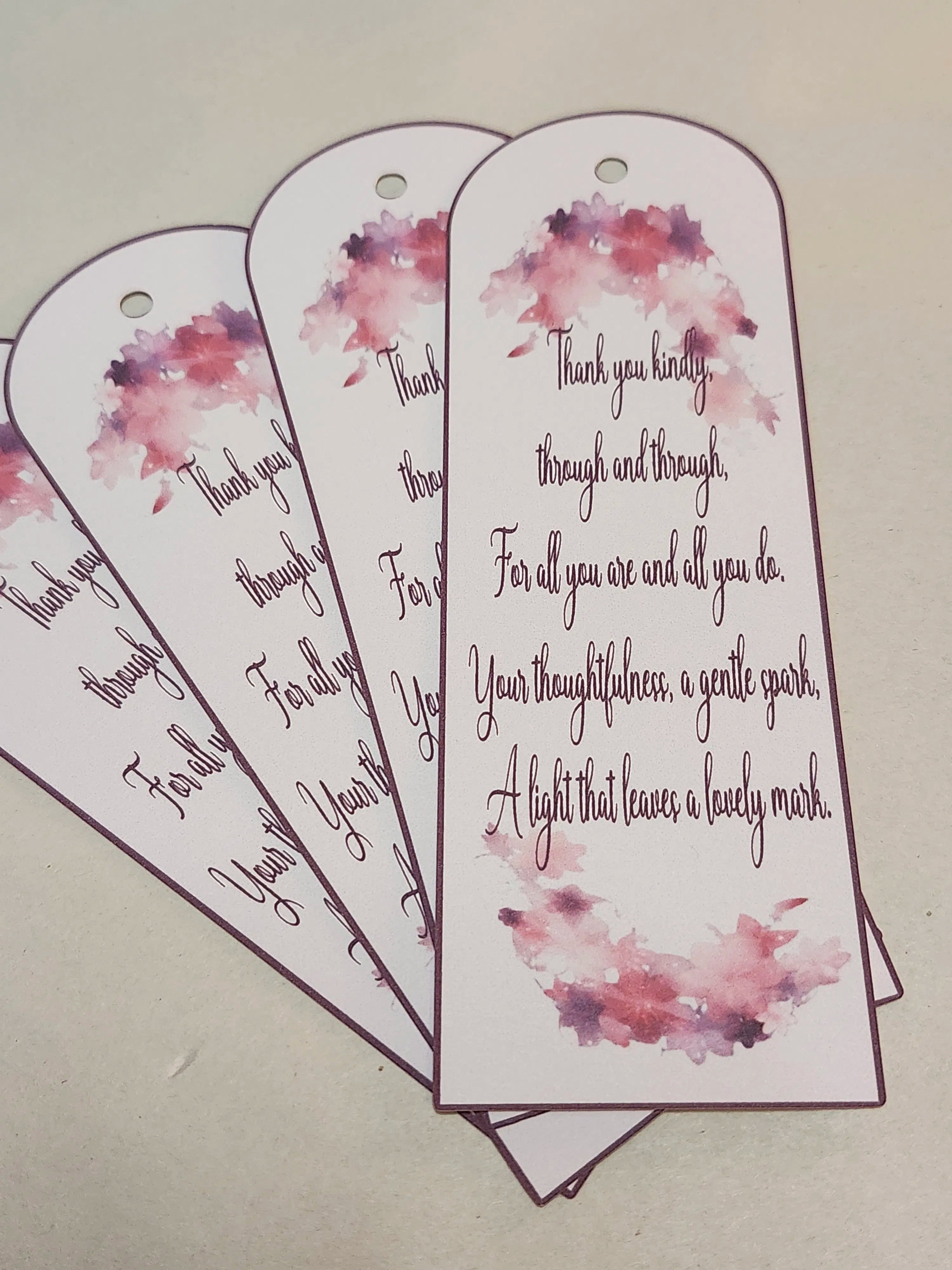 Bookmarks with floral designs and heartfelt messages on a beige background