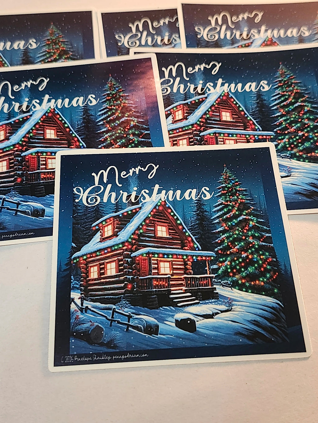 Collection of Christmas stickers with snowy scenes, cabins, and trees.