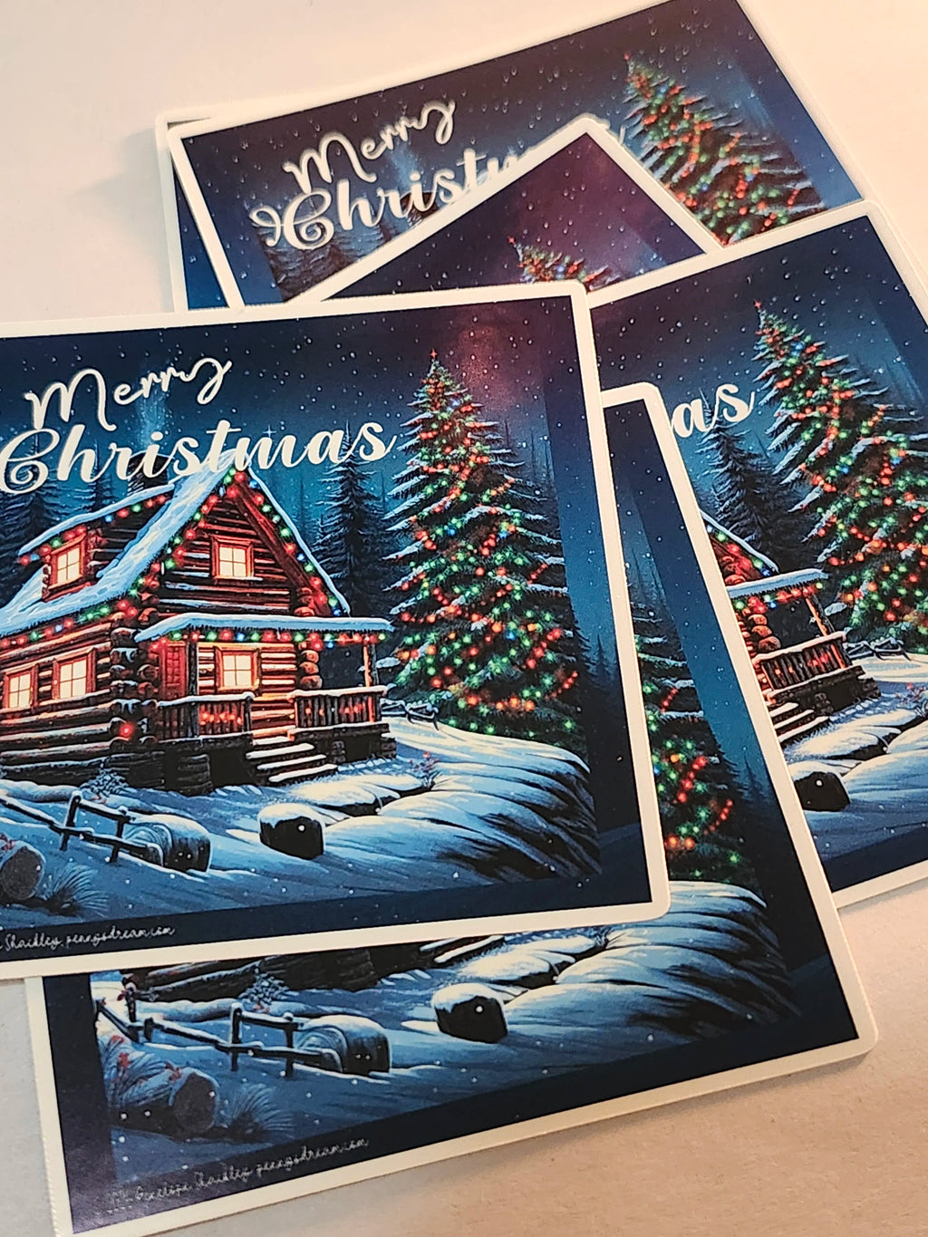 Christmas-themed stickers with snowy landscapes and decorated trees.