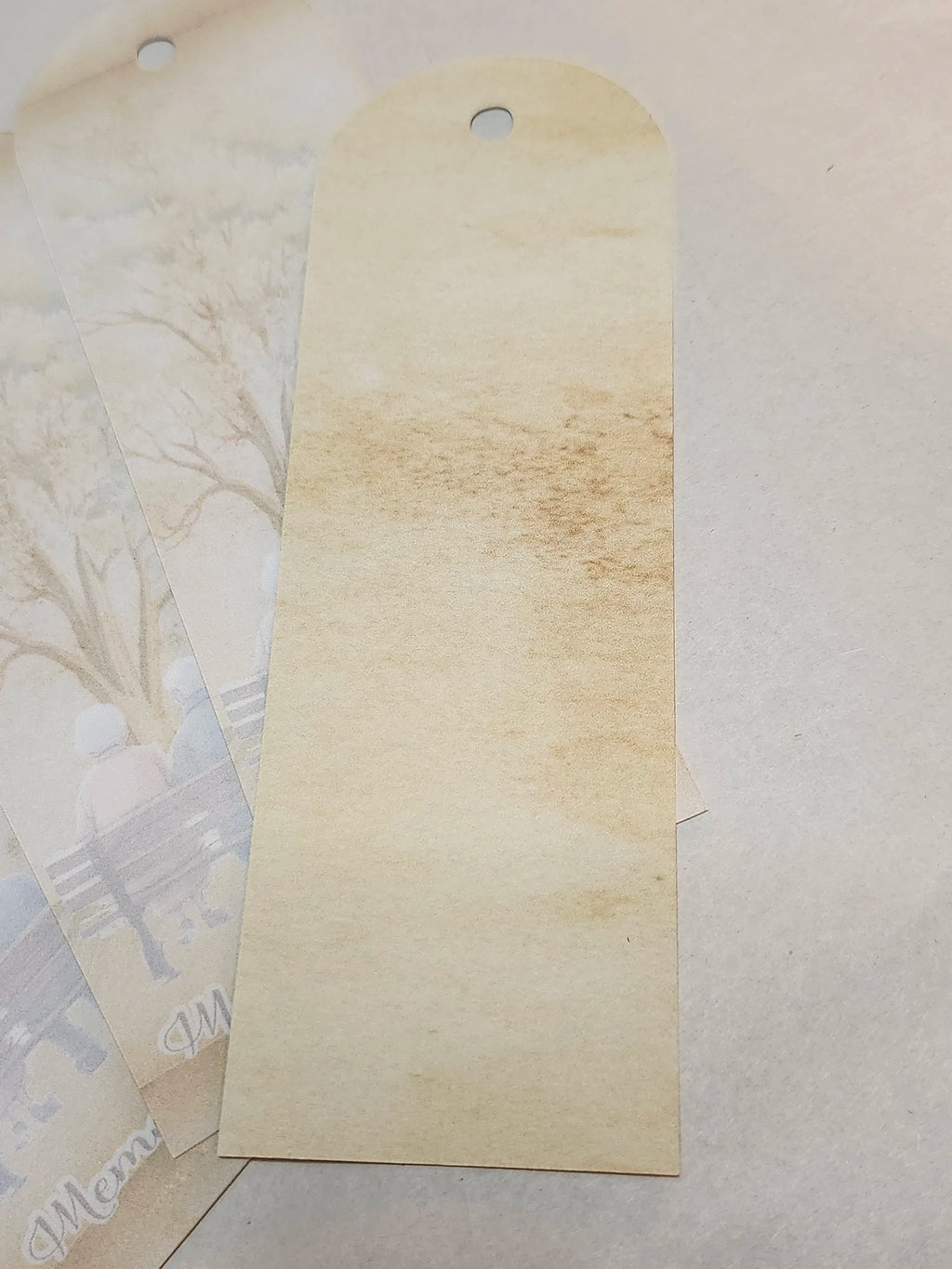 Beige paper tag with a textured surface on a light gray background