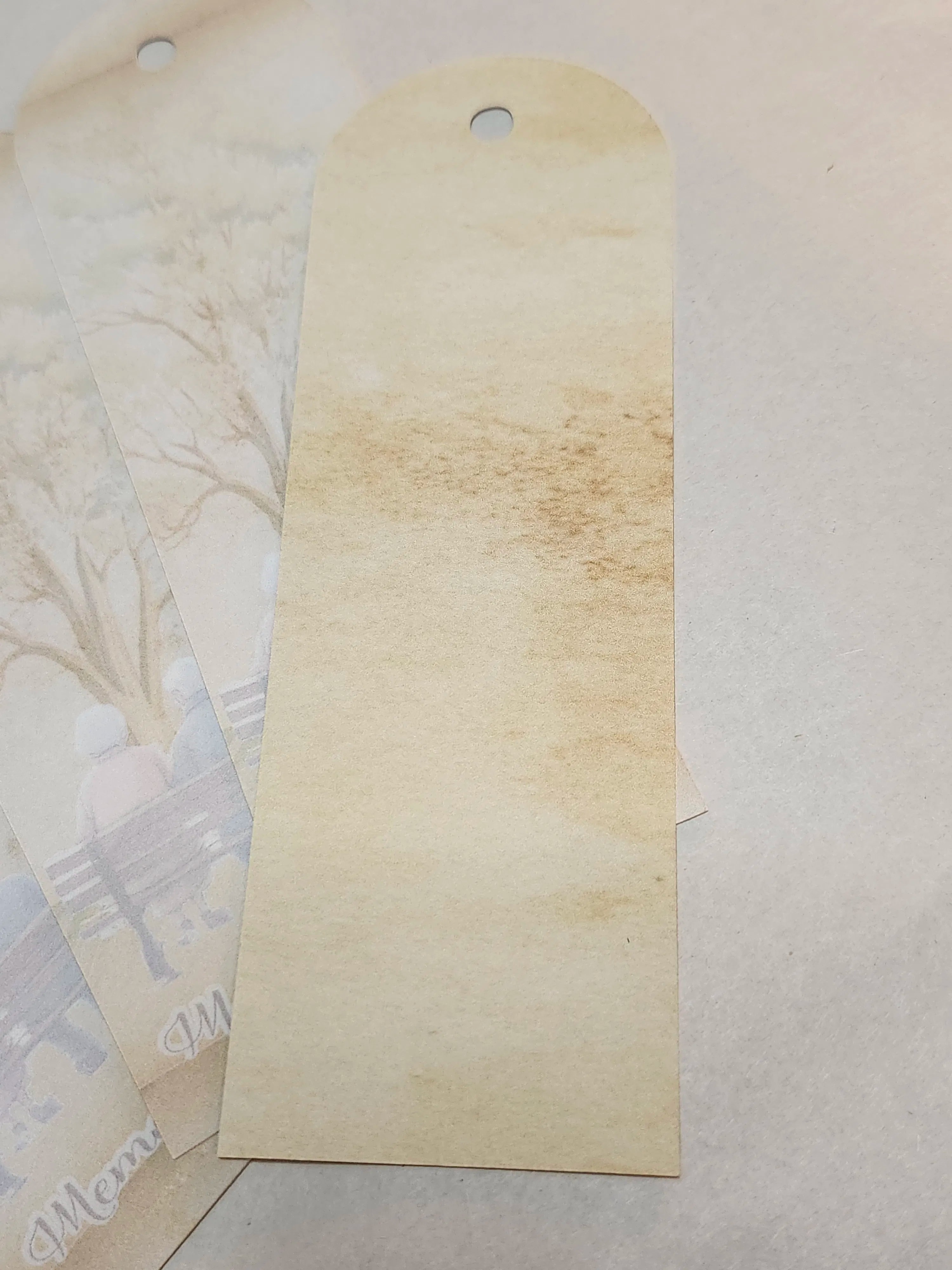 Beige paper tag with a textured surface on a light gray background