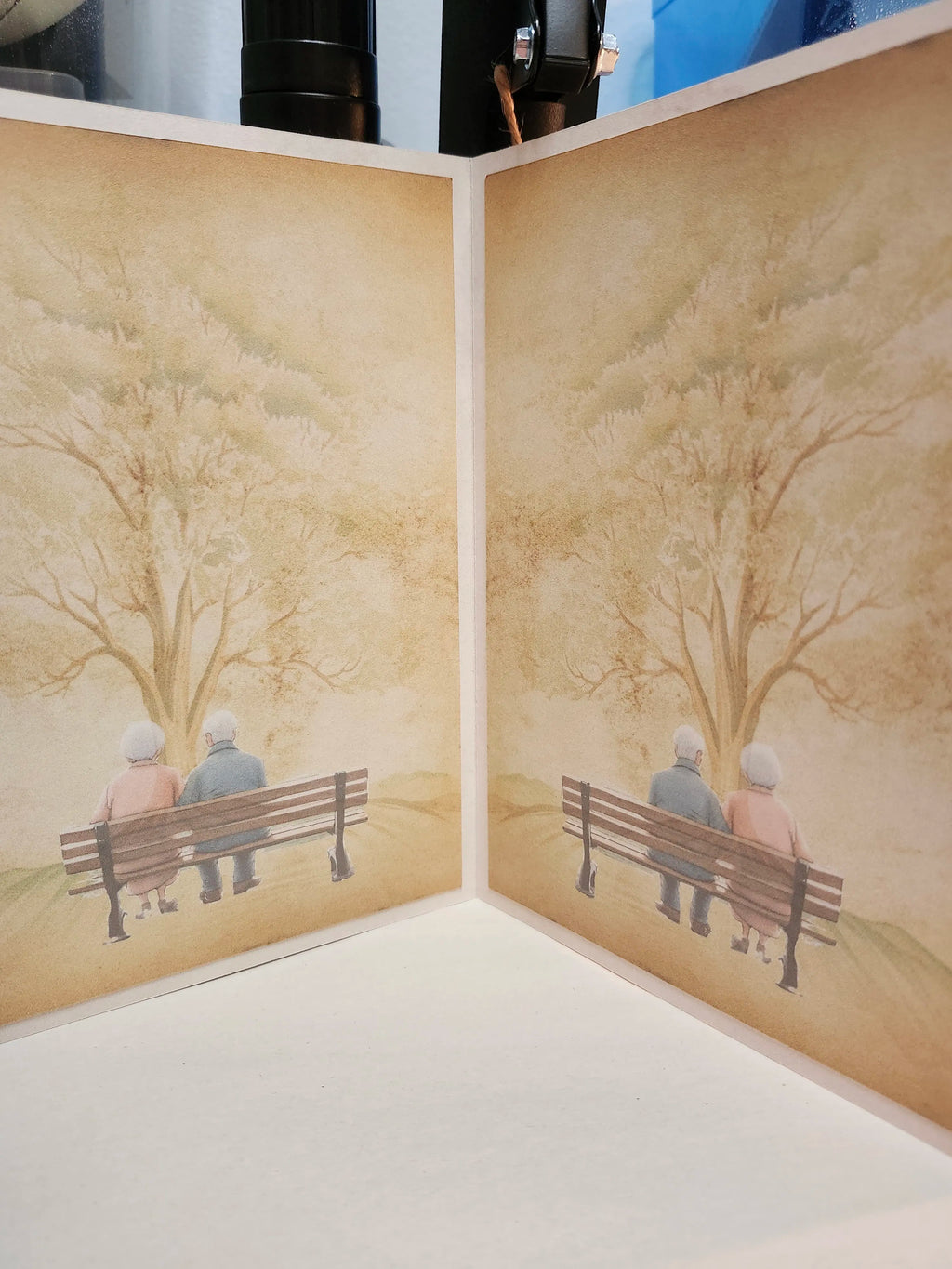 Artistic depiction of two people on a bench with trees in the background