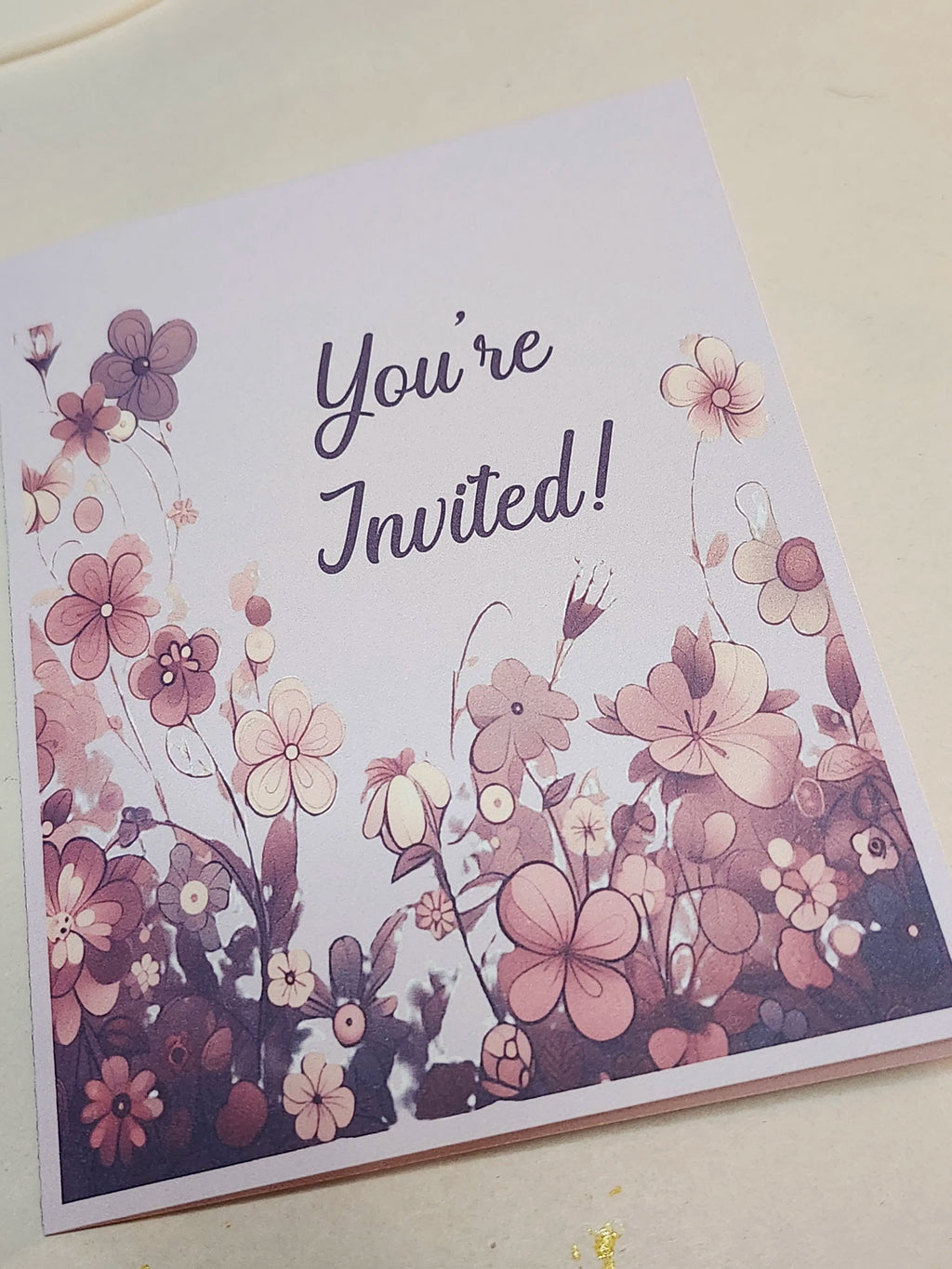 Floral invitation card with 'You're Invited!' text on a white background