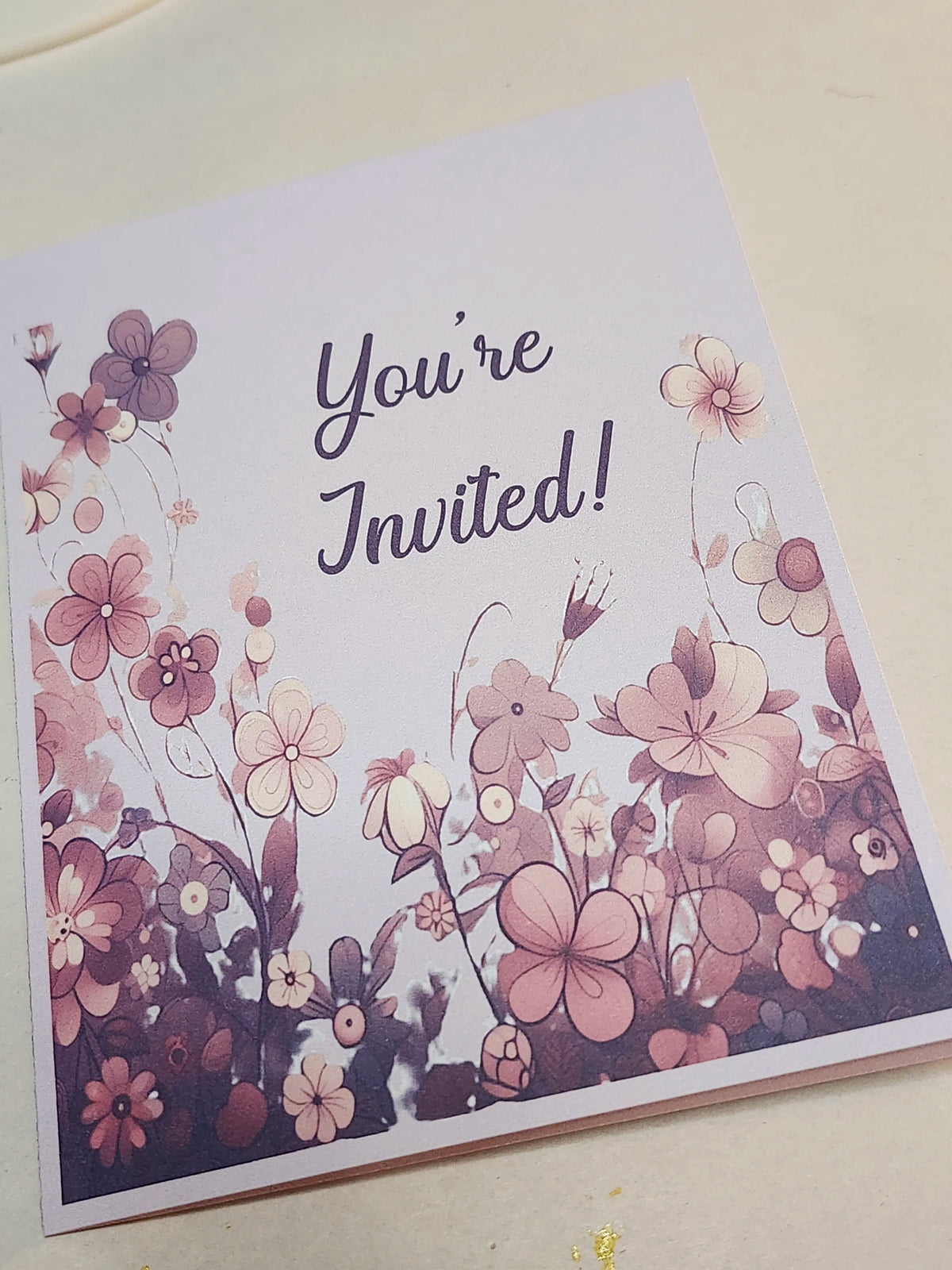 Floral invitation card with 'You're Invited!' text on a white background