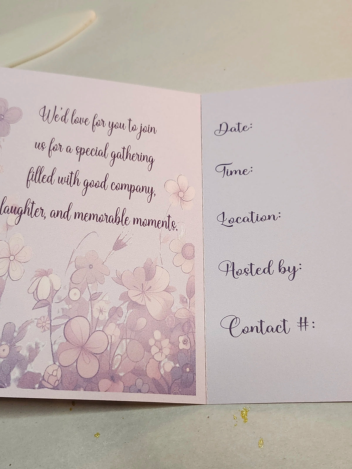 Invitation card with floral design and text fields on a light background