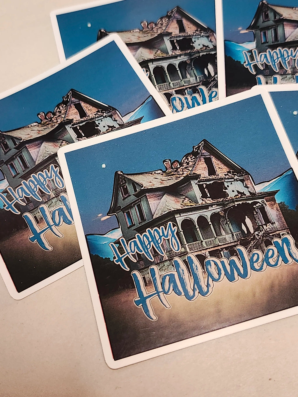Halloween-themed stickers with haunted house design and 'Happy Halloween' text.