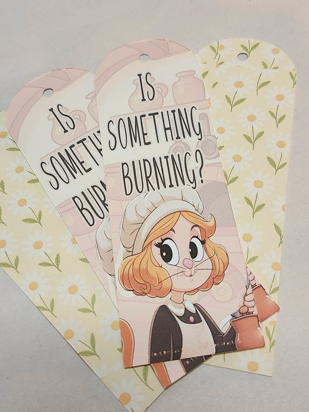 Cartoon character with text 'Is something burning?' on a floral background