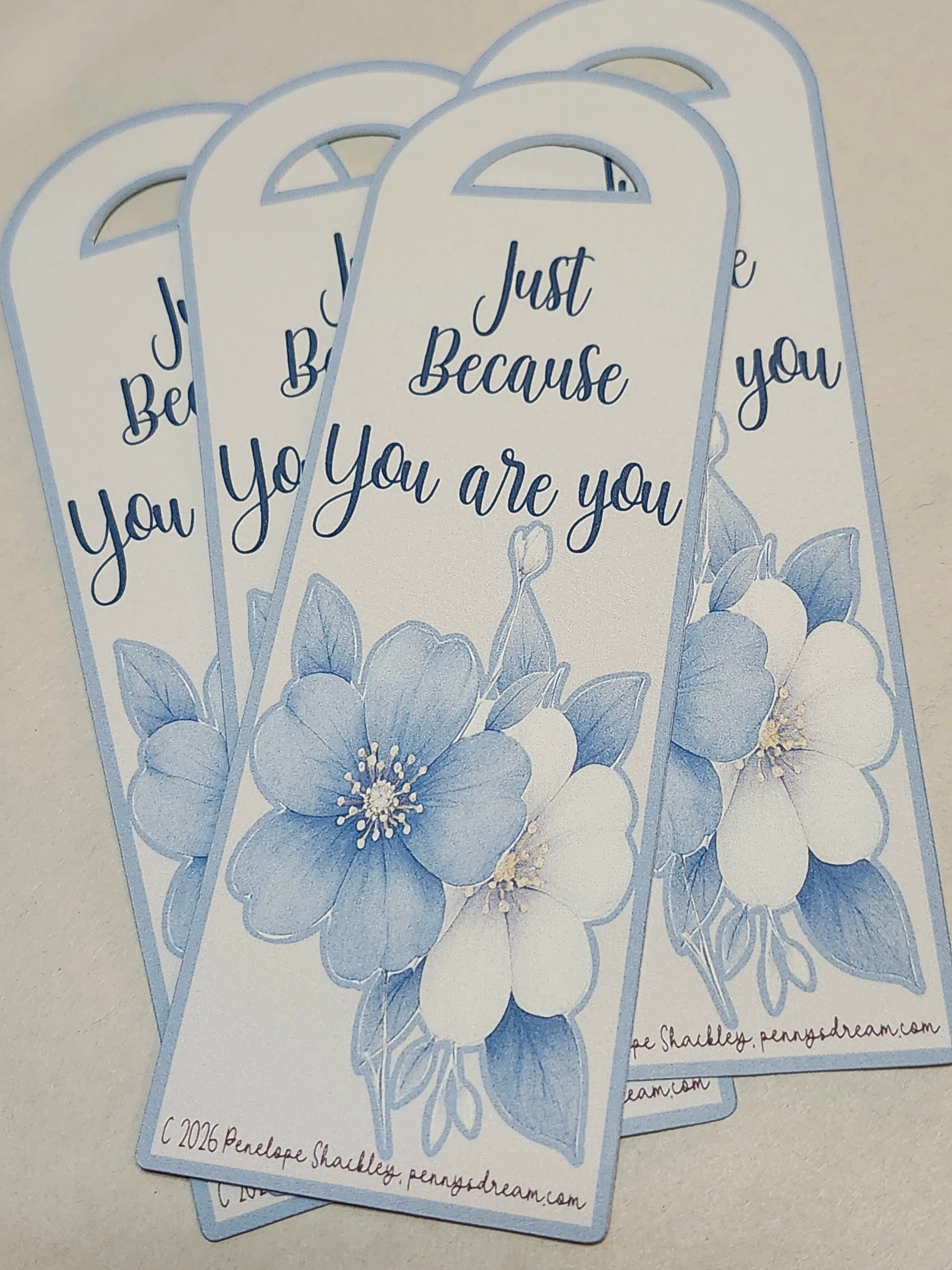Three floral-themed bookmarks with blue and white flowers and text on a beige background.