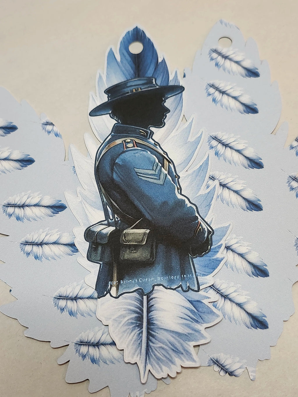 Silhouette of a person in uniform with decorative wings on a beige background