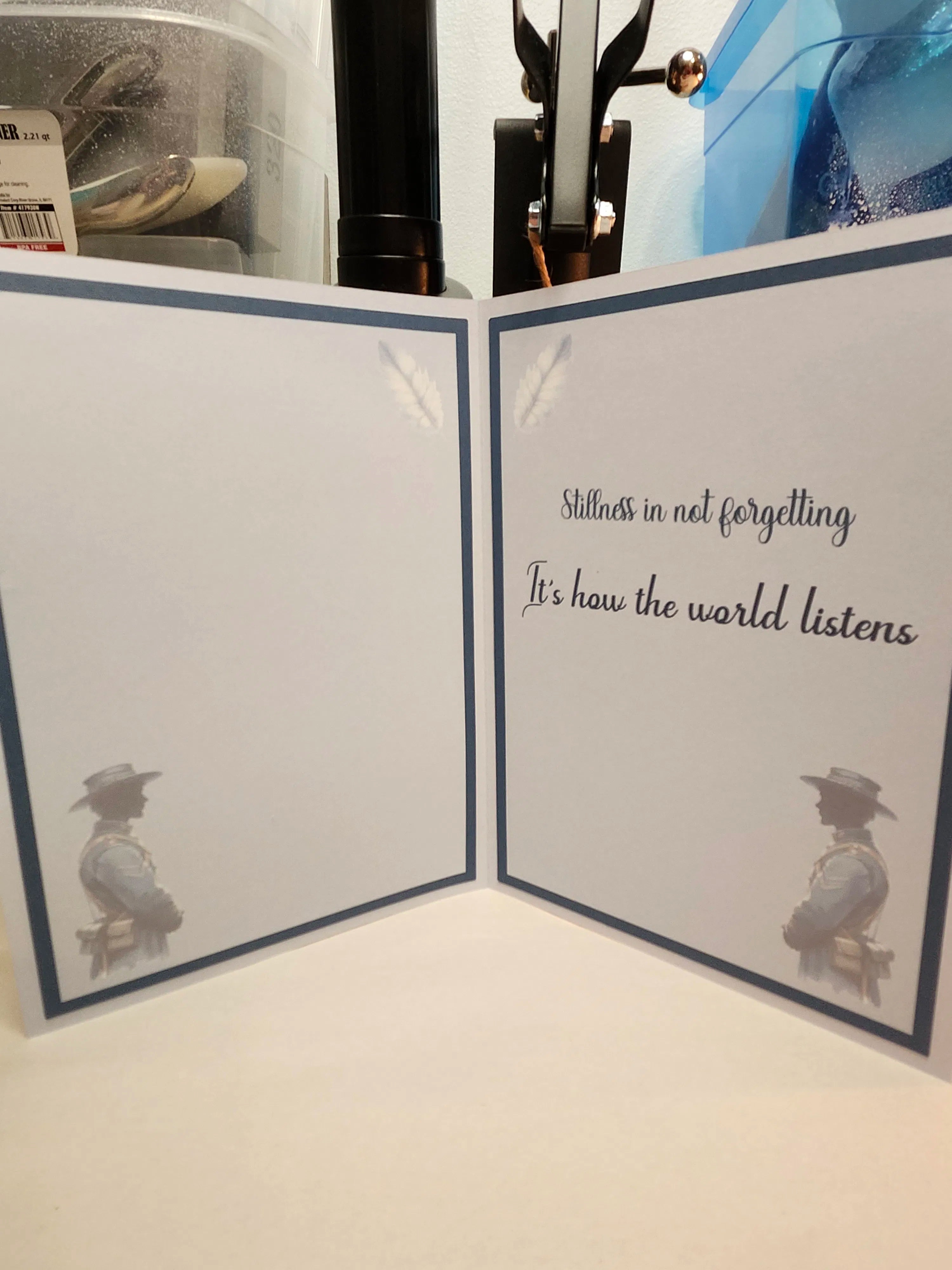 Open card with text 'Silence is not forgetting. It's how the world listens' and illustrations of a person and a bird.