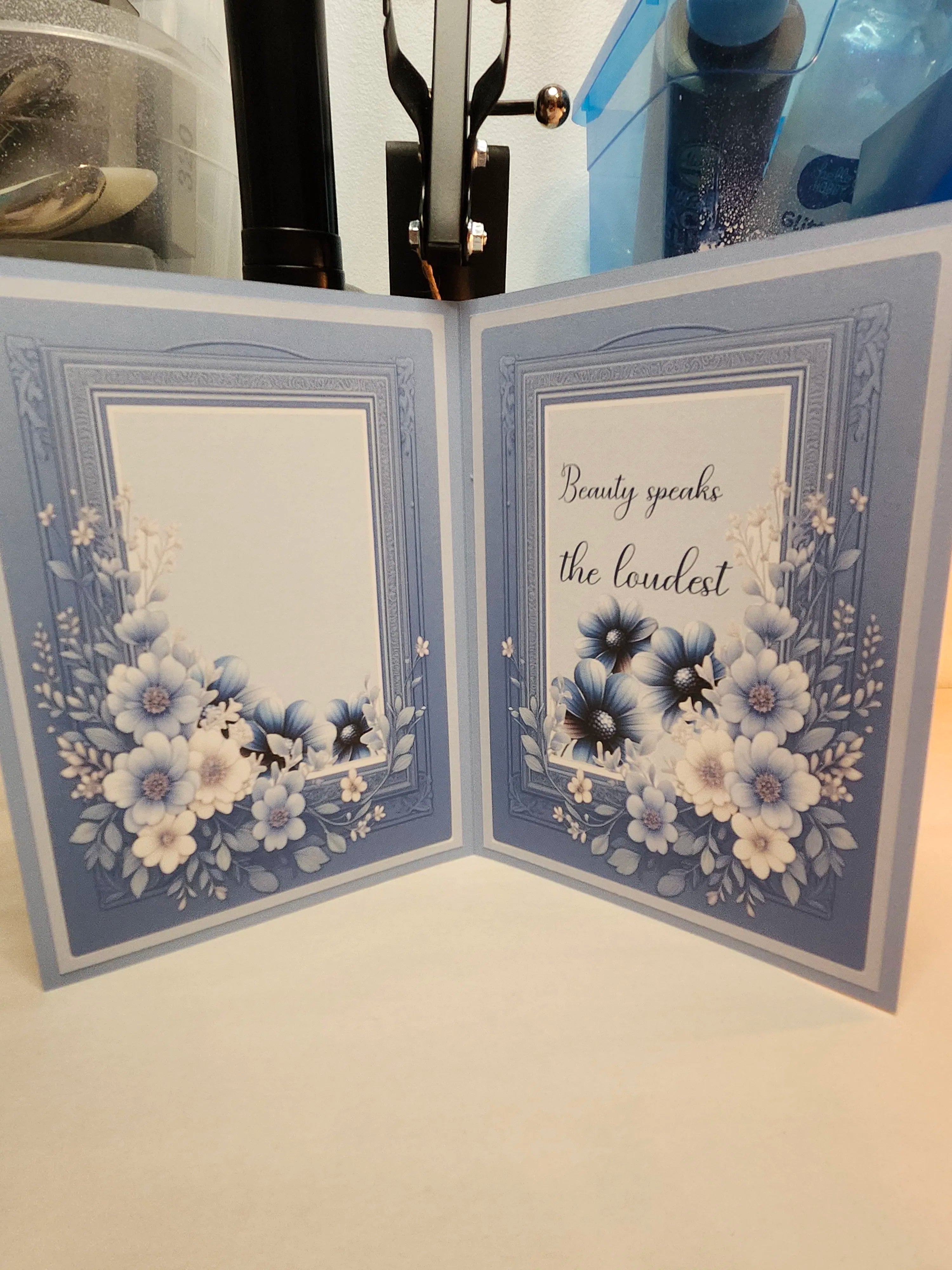 Open card with floral design and text on a white background