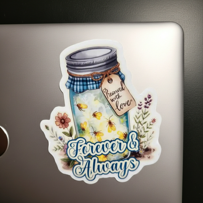 Sticker of a jar with flowers and text 'Forever & Always' on a metallic surface.