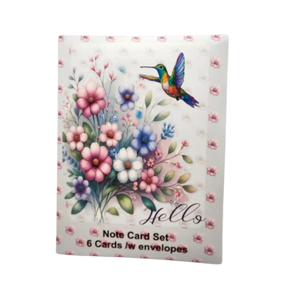 Note card set with floral design and hummingbird on a white background