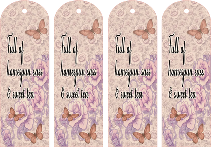 Four identical decorative bookmarks with butterfly designs and text on a floral patterned background.