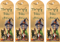 Four identical bookmarks featuring a witch, black cat, and pumpkin with text 'The fog tells stories' on a gold background.