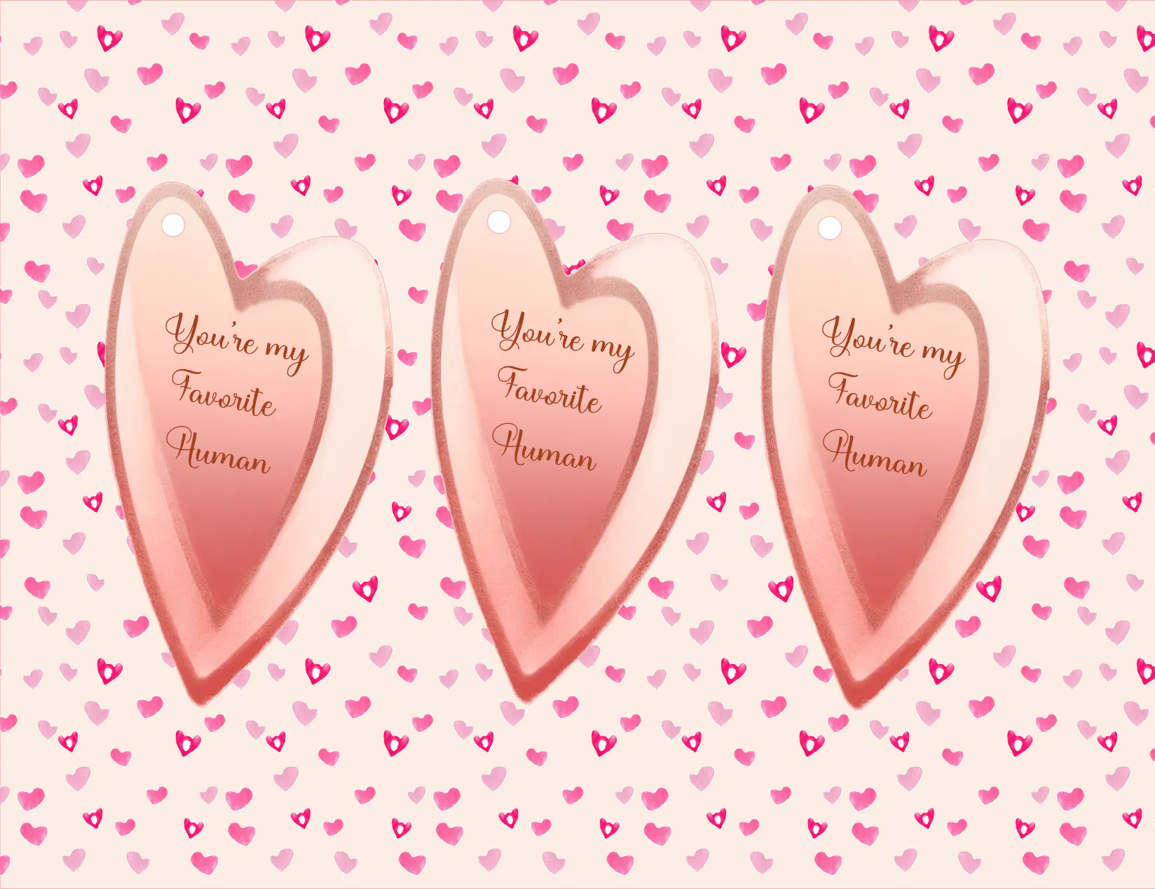 Three pink heart-shaped hanging tags with the phrase 'You're my Favorite Human' in gold script, displayed against a light pink background patterned with small hearts.