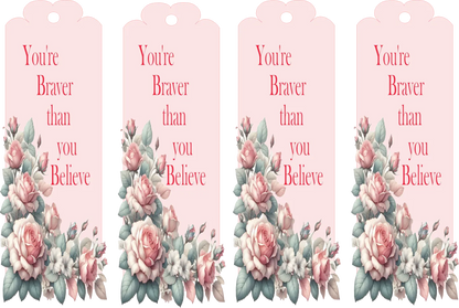 Four pink tags with floral designs and motivational text on a white background