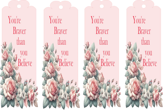 Four pink tags with floral designs and motivational text on a white background