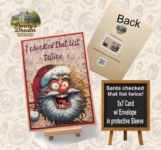 Card with Santa Claus illustration and text 'I checked that list twice.' on a stand, with an envelope and label in the background.