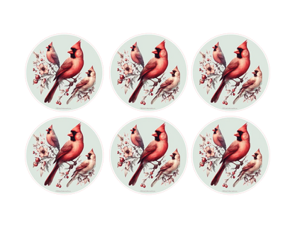 Set of six circular coasters with red cardinal birds on branches.